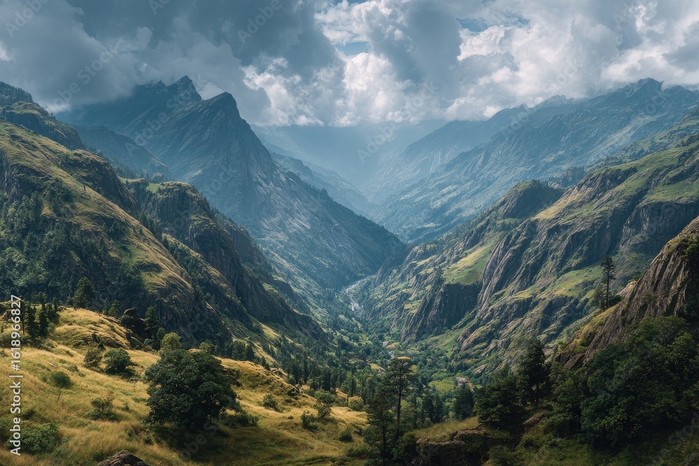 Fototapeta premium Majestic mountains reach into a cloudy blue sky with misty valleys below in the range, a breathtaking and serene vista of nature's grandeur and mountain peaks covered in snow