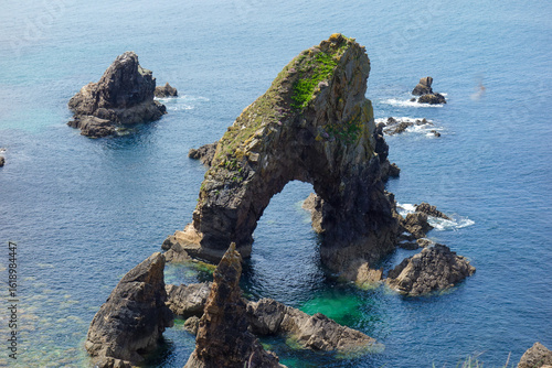 The famous Crohy Head Sea Arch Rises from the Atlantic Waters in the Donegal region in Ireland Europe .