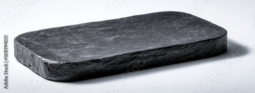 Rustic black stone tray on white, minimalist background; ideal for serving food or home decor
