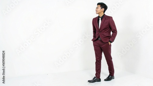 Full-Body Shot of a Young Man in a Burgundy Suit
Stylish and Confident Male Model in Formal Attire
Fashion Portrait of a Man Posing in a Studio
Elegant Gentleman in a Bold Burgundy Business Suit