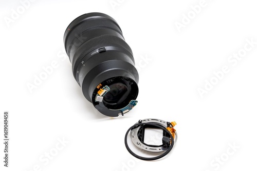 Fotografie Broken camera lens with detached bayonet mount on white background