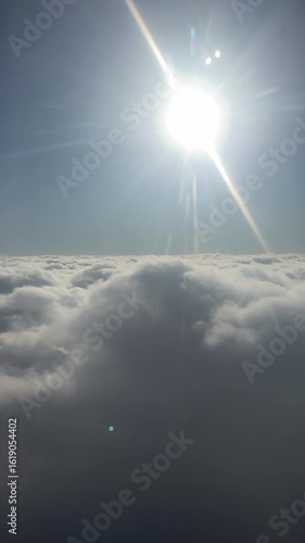 Glimpses of light filter through thick grey clouds, capturing the peaceful isolation and stillness of flying above the storm. Loopable video