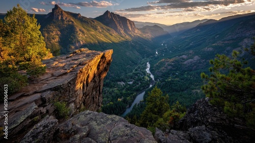 Mountain vista from a rocky overhang.  Sunset hues paint valley below