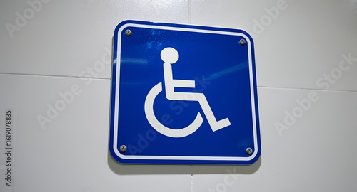 Universal Accessibility Symbol Sign on a Wall for Wheelchair Access and Inclusive Public Spaces