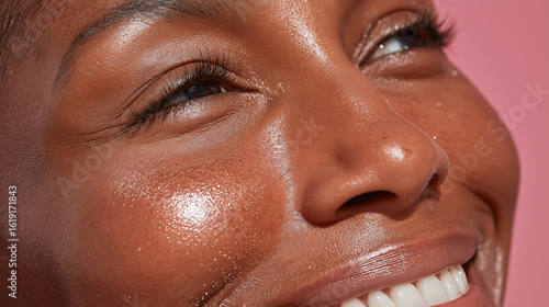 Wallpaper Mural Glowing skin close up of plus size person with smooth dark complexion smiling happily with natural makeup and long eyelashes on pink background Torontodigital.ca