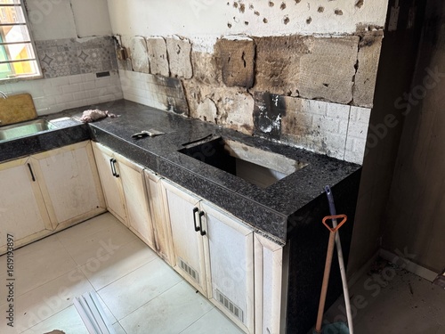Photos Burn marks from a fire scar the kitchen tabletop cabinet and the shelf area beneath it