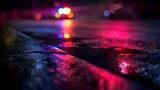 Police lights reflecting on wet pavement at night, creating a vivid urban atmosphere.