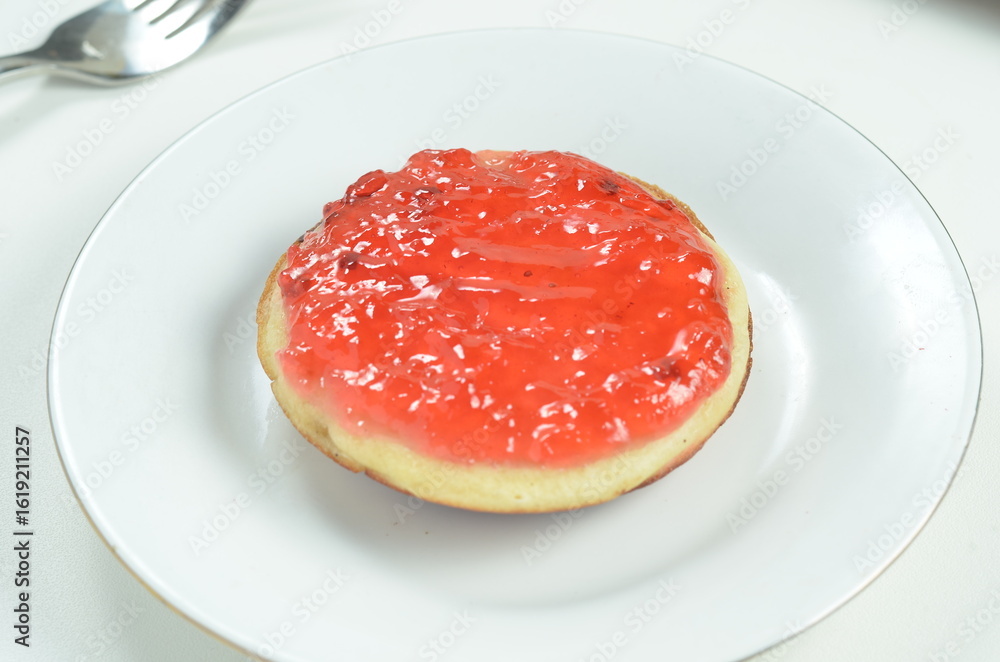 Serabi pancakes topped with strawberry jam, a traditional Indonesian snack Serabi pancakes topped with strawberry jam, a traditional Indonesian snack