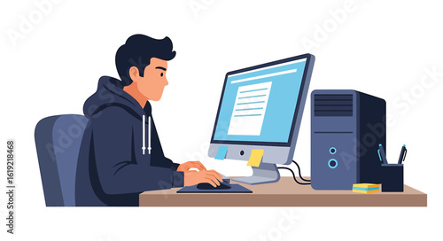 A young man wearing a hoodie sits at a desk and types on a desktop computer, working on a document.