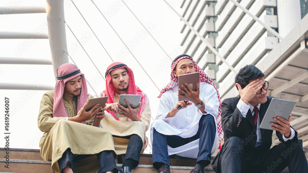 Fototapeta premium Multicutural Group of people diversity men talking look at digital tablet smile face. Empowering communication happy multiethnic muslim man and businessman team partner discussion in city street