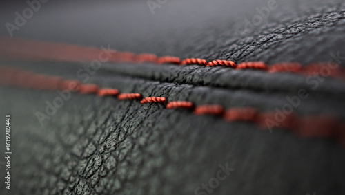 Red stitch on black leather of luxury sports car