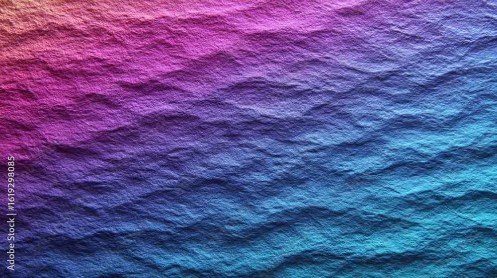 Obraz premium Colorful textured water surface with vibrant purple blue and pink hues reflecting light and creating a mesmerizing abstract pattern