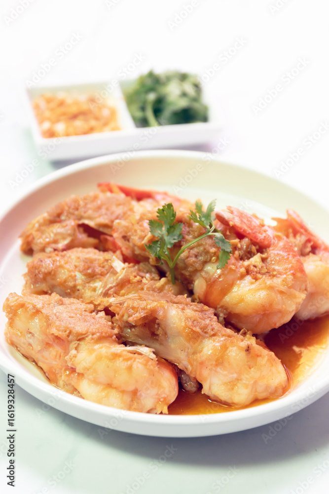 A delicious plate of fried shrimp garnished with herbs, served with side sauces for a tempting culinary experience. A delicious plate of fried shrimp garnished with herbs, served with side sauces for a tempting culinary experience.