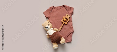 Baby bodysuit with toys on ...
