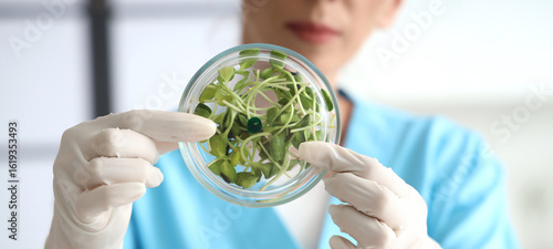 Female scientist with Petri...