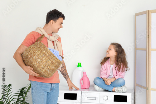 Young father with laundry b...