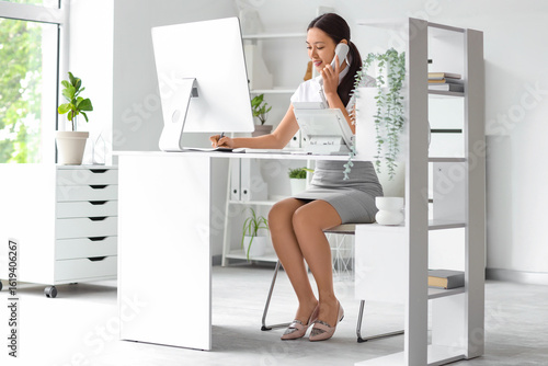 Young female receptionist a...