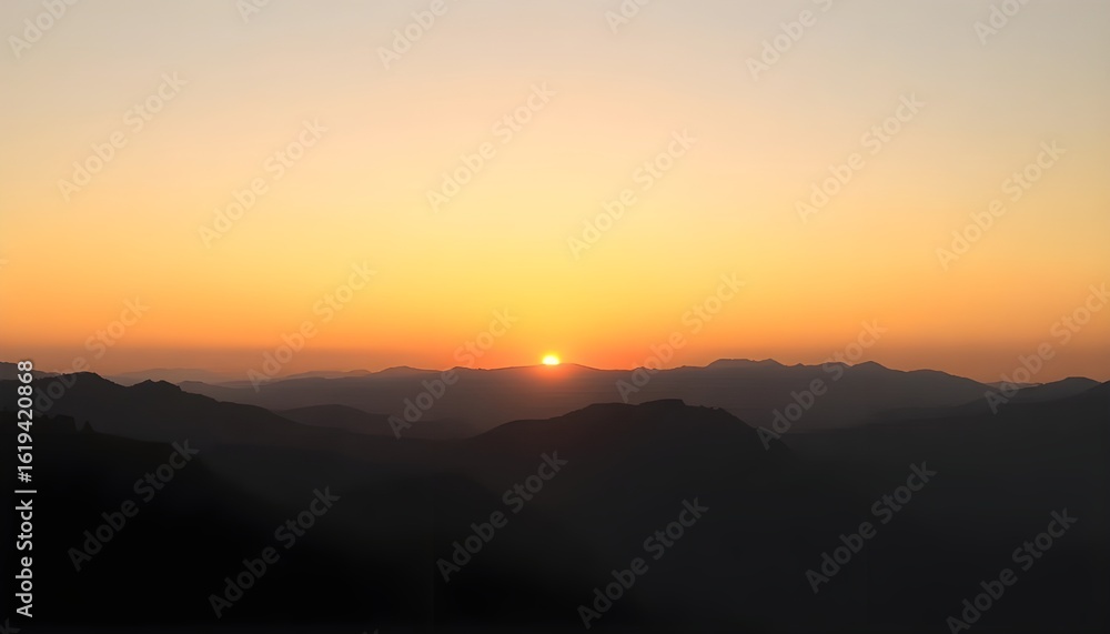 Obraz premium Sunset behind mountain ridges during summer evening with glowing horizon and pastel gradient sky.