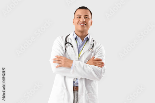 Handsome doctor on white ba...