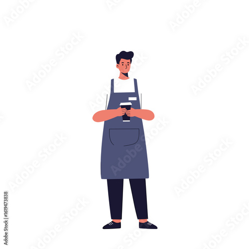 Young man holding a coffee cup and wearing apron indoors  