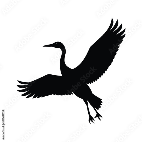 Dramatic silhouette of a crane in flight against a stark white background