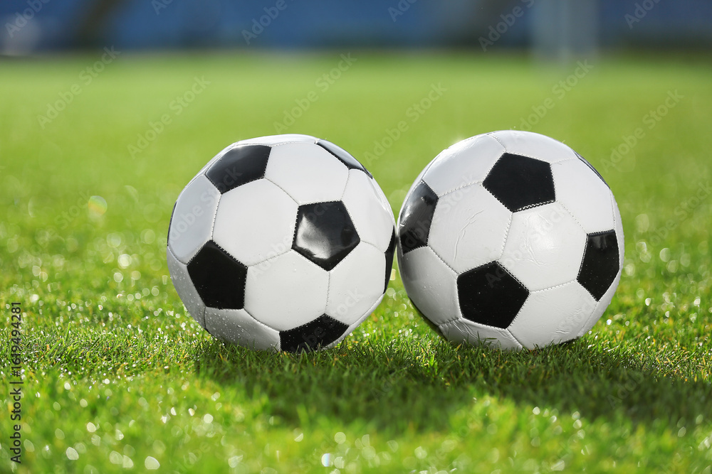Fototapeta premium Soccer balls on green stadium grass