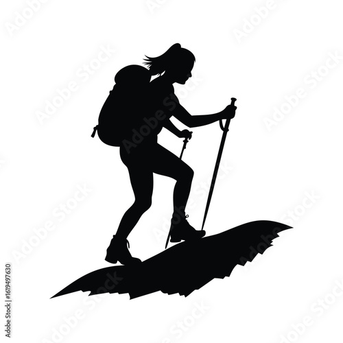 Silhouette of a female hiker with a backpack using trekking poles