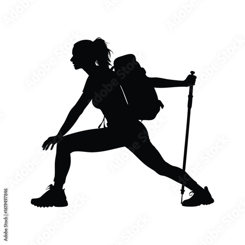 Silhouette of woman hiker stretching with trekking poles and a backpack