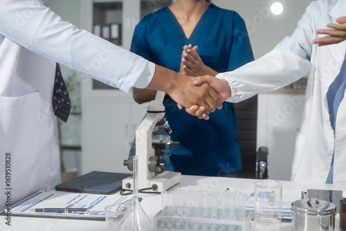 Wallpaper Mural A handshake between scientists, researchers, or medical professionals signifies a successful agreement, marking the start of collaboration, partnership, or joint development in healthcare, science Torontodigital.ca