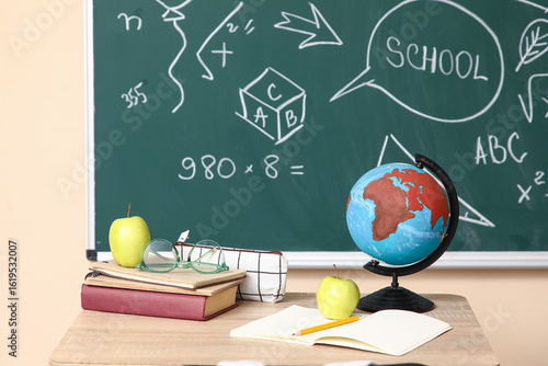 School desk with globe, app...