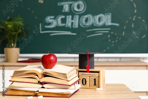 School desk with books, app...