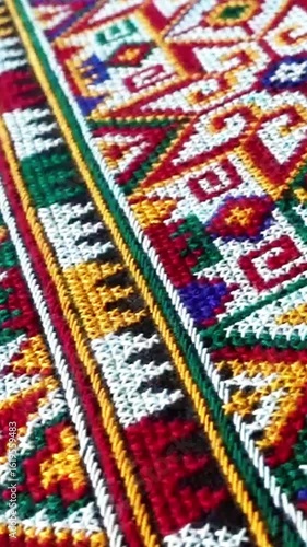 Close-up of traditional Yao Mien textile featuring intricate hand embroidery and colorful tribal patterns. This ethnic needlework reflects the rich cultural heritage and skilled craftsmanship of the Y