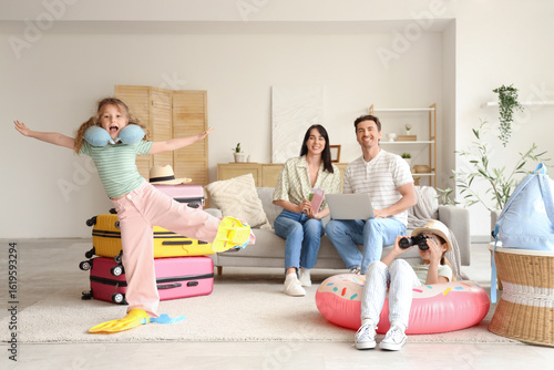 Family of tourists with lap...