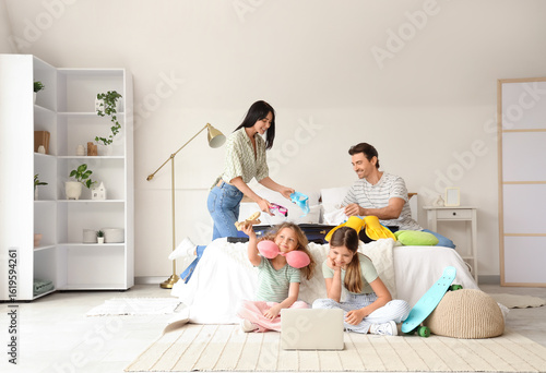 Family of tourists with lap...