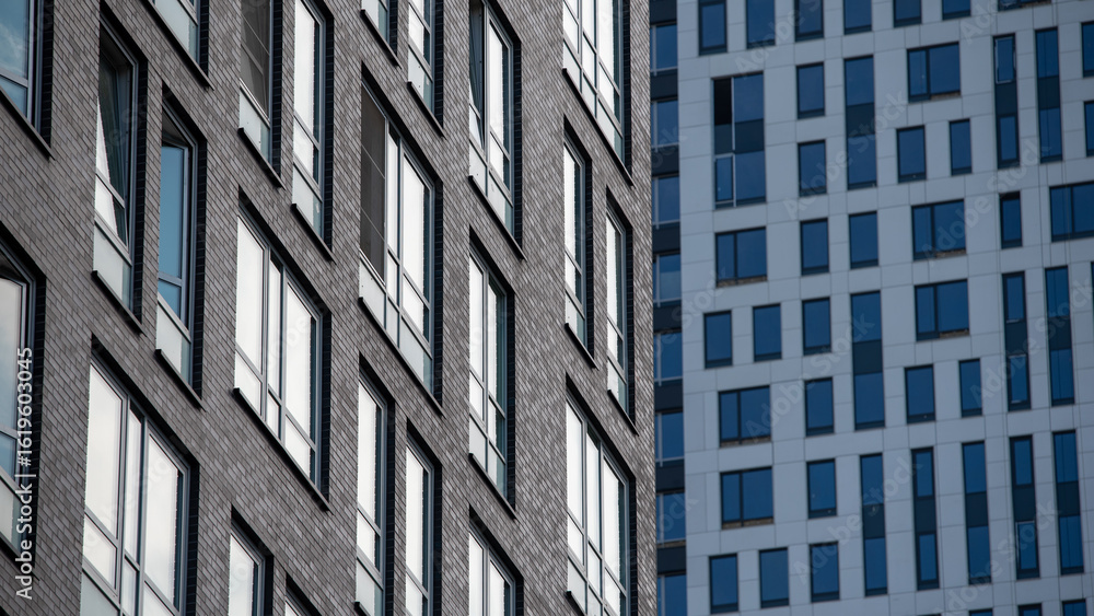 empty glass windows of a modern building with a reflection of the sky in the glass empty glass windows of a modern building with a reflection of the sky in the glass