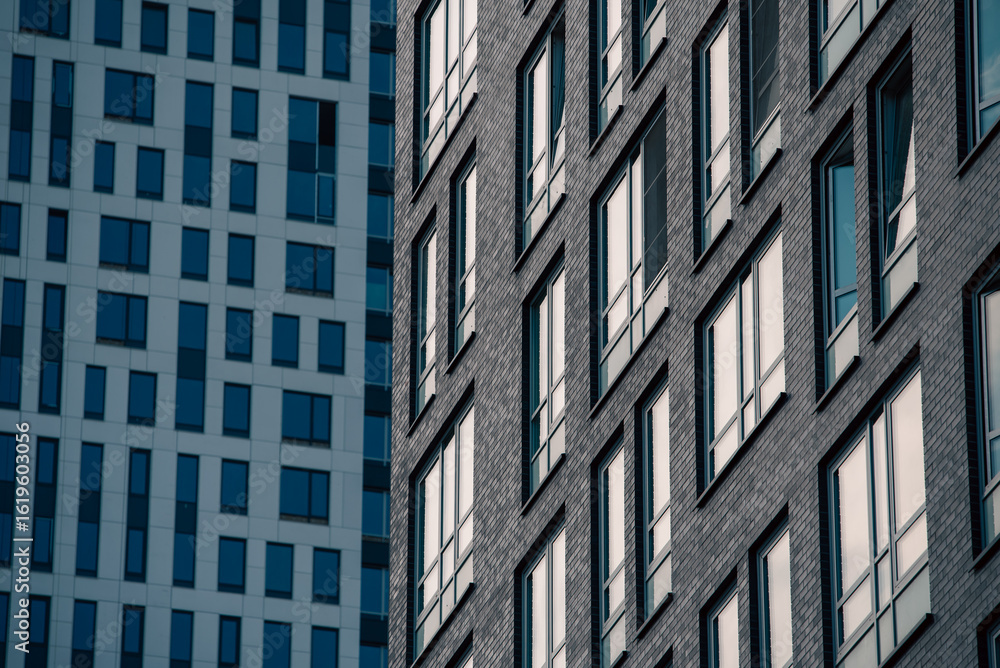 Fototapeta premium empty glass windows of a modern building with a reflection of the sky in the glass