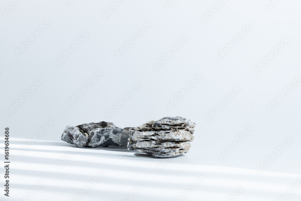 Naklejka premium nature gray pebble stone gravel and grey boulder rock on desktop tabletop white clean background