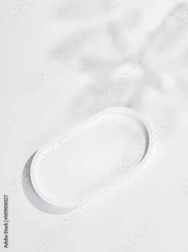 empty isolated white clean simple plaster tray and oval ceramic base stand with tree shadow and shade silhouette on desktop tabletop display background
