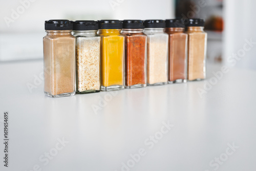 organised tidy spice jars on kitchen countertop featuring pantry staples and different flavours for home cooking