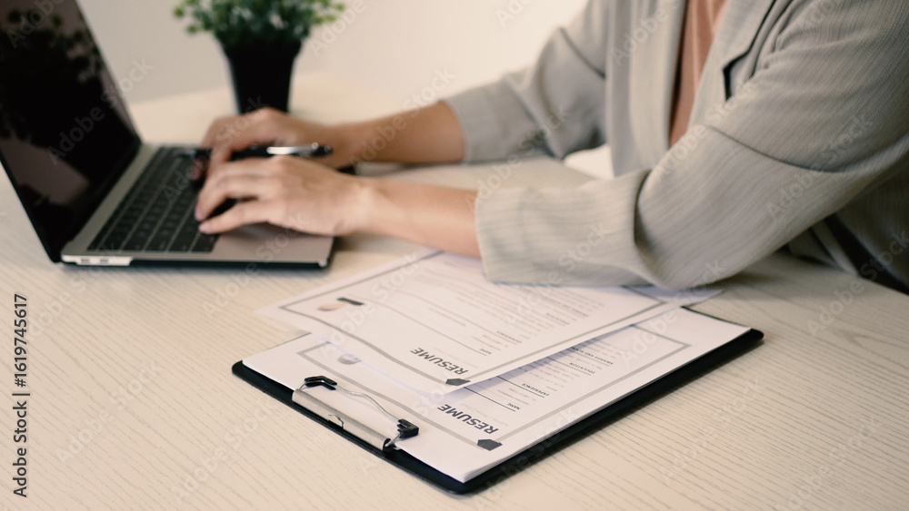 Fototapeta premium Businesswoman employer holding resume, recruiting, planning, evaluating and reviewing resume of job applicant, recruiting new employees, recruitment concept