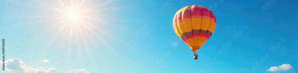 Naklejka premium A vibrant hot air balloon ascends into a clear, sun-drenched sky, its bright colors a stark contrast to the azure expanse Perfect for travel, adventure, freedom, and summer themes , freedom, vista