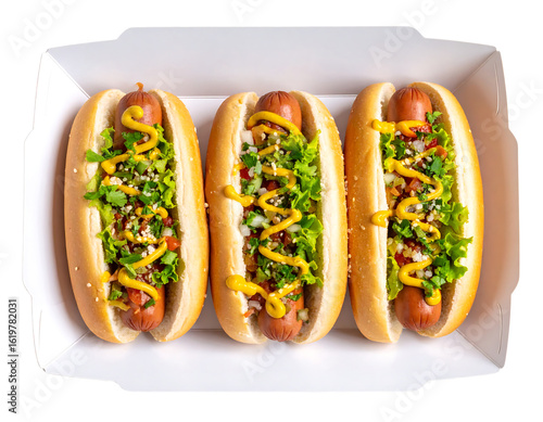 Three delicious hot dogs in a white takeout box, topped with mustard, lettuce, and a vibrant relish isolated on transparent background.