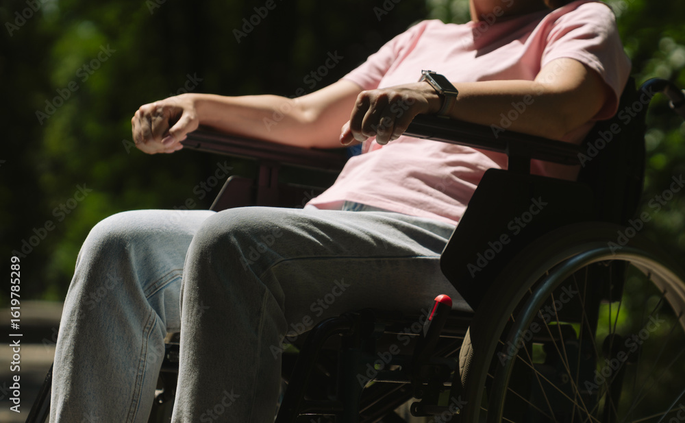 Person Relaxing Outdoors in a Wheelchair on a Sunny Day Person Relaxing Outdoors in a Wheelchair on a Sunny Day