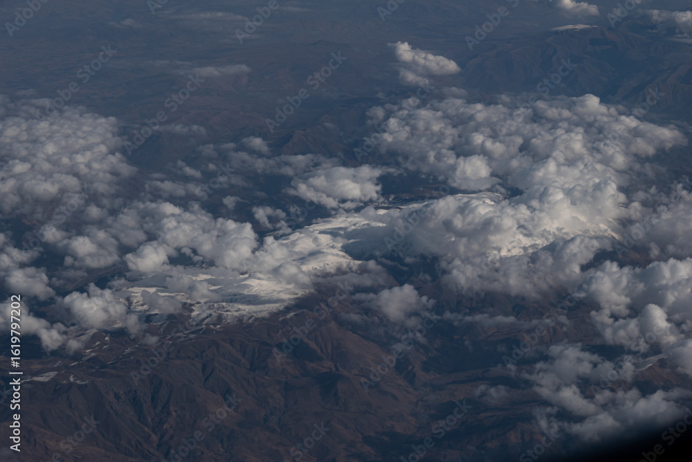 Fototapeta premium Clouds Rolling Over Mountainous Terrain