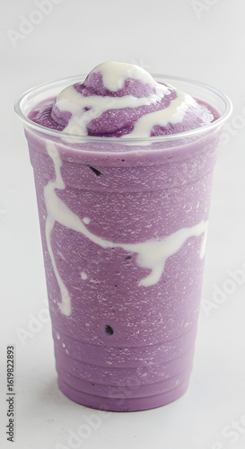 An iced taro coconut cream frappe in a clear plastic cup with a rounded base, isolated on a white background.