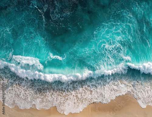 Aerial view of turquoise waves crashing on a sandy beach (2)