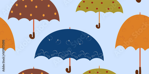 Seamless vector pattern of whimsical autumn umbrellas in various colors and designs, including polka dots, mushrooms, and maple leaves, on a light blue background. Ideal for fall weather themes.
