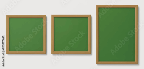 Three empty green chalkboards with wooden frames arranged side by side