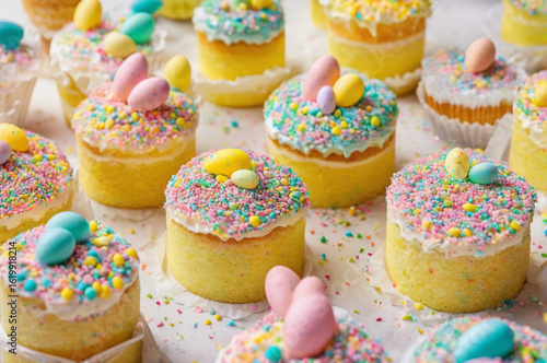 Colorful Easter Cupcakes with Candy Eggs and Sprinkles. Generative AI.