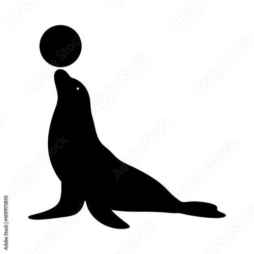 Silhouette of a sea lion balancing a ball on its nose